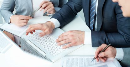 Group of business people working with laptop at meeting